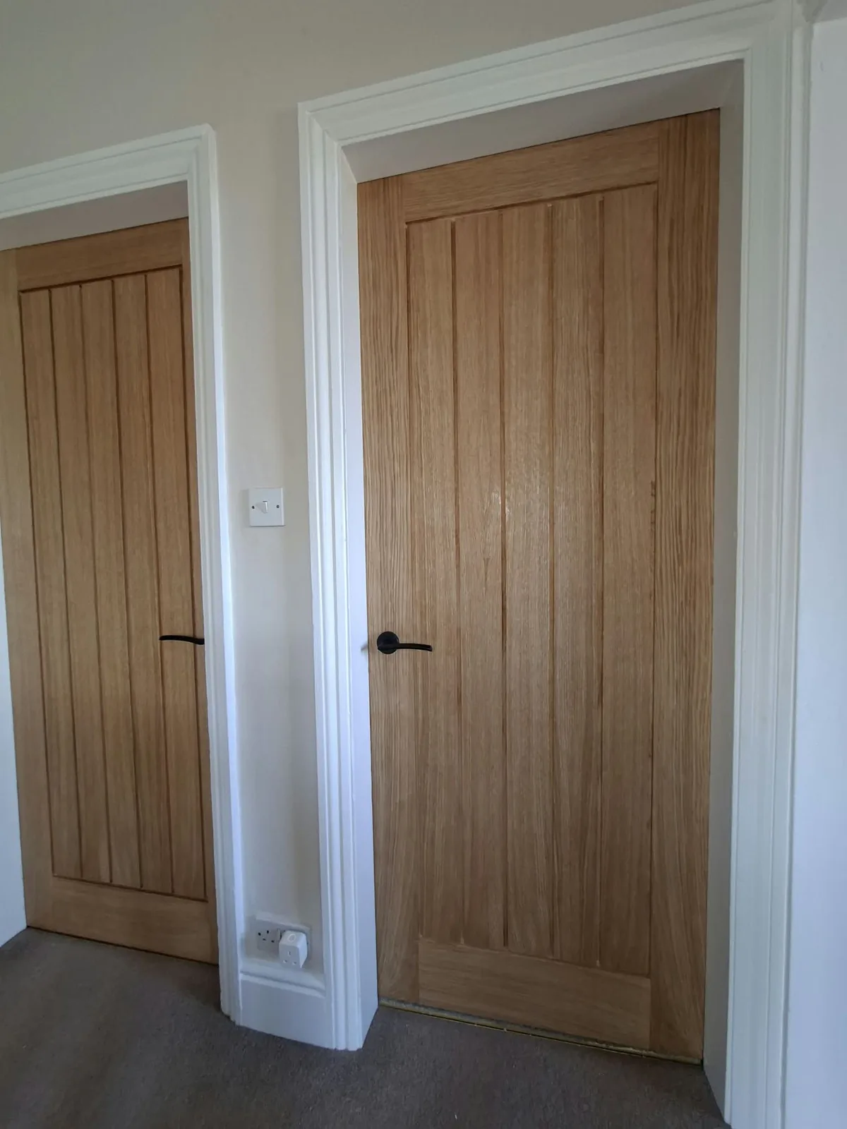 Oak internal door fitted with black ironmongery